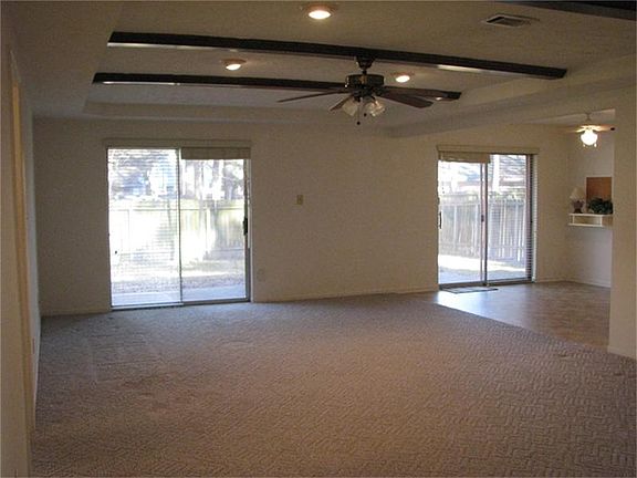 Two glass doors give lots of natural light and open to oversized backyard patio