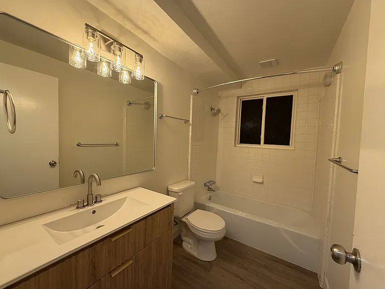 Bathroom with new mirror, vanity, and light