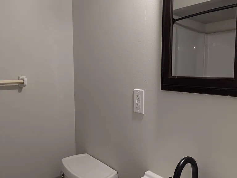 Remodeled bathroom with all matte black faucets