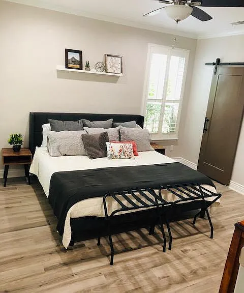 Master bedroom is the only bedroom located downstairs and has sliding barn door leading to full bathroom. Also has a walk in closet.