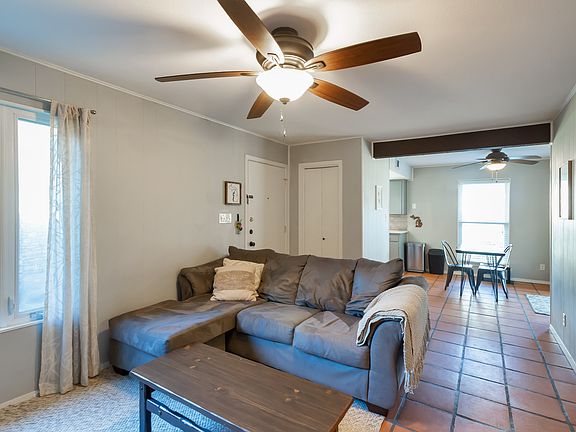 Living area, opposite view. Closet to right for coats. Kitchen/dining in background.
