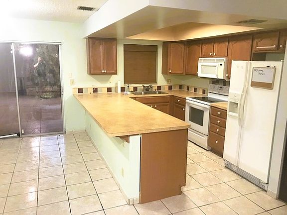 kitchen and sliding glass door out to screened-in lanai and laundry room