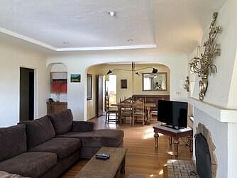 View from living room to dining room, with kitchen beyond