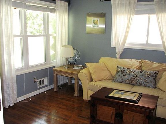 Open living room, bright and sunny with hardwood floors and new windows throughout