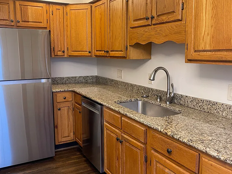 kitchen with plenty of storage cabinets and large single bowl stainless sink , granite countertops and new moen faucet, also stainless refrigerator