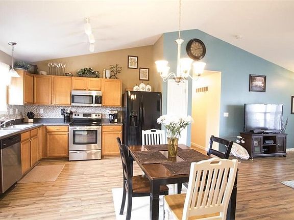 Open Concept with vaulted ceilings.  Newer backsplash in Kitchen.
