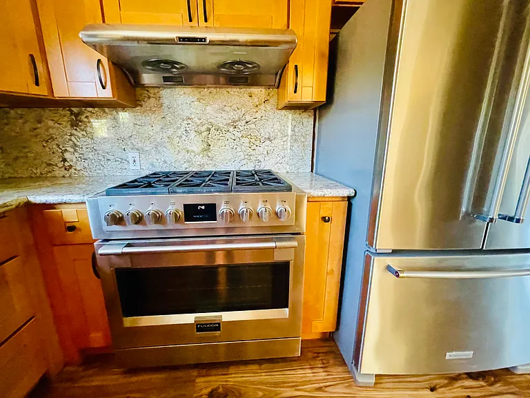 Large Italian 6 burner gas stove and hood and stainless steel refrigerator