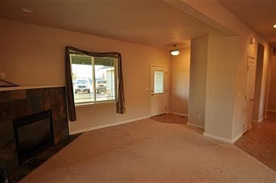 Another view of living space and front entry.