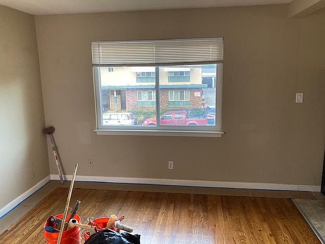 living room, hardwood floors, mini blinds, fresh paint