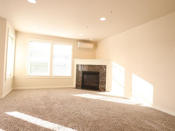 Living room with fireplace and AC