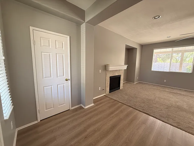 Walking in front door, coat closet on the left, fireplace, big windows.