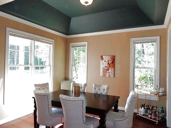 As you enter the foyer, the dining room is to your left. Notice the unique tray ceiling and large wi