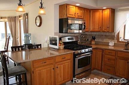 Kitchen
						:
						Recessed lighting complements the gorgeous Kitchen