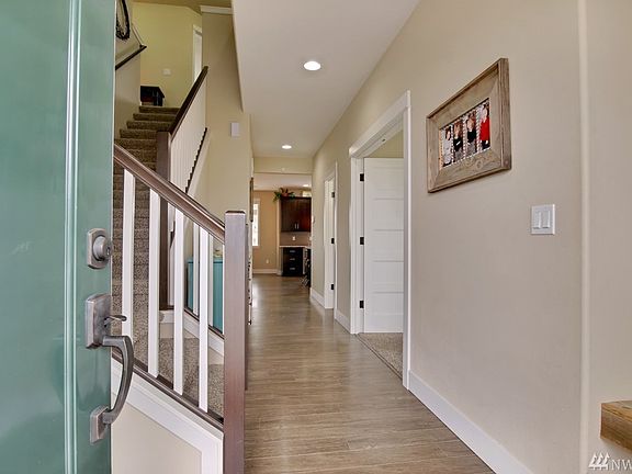 Entry opens to gleaming laminate flooring.