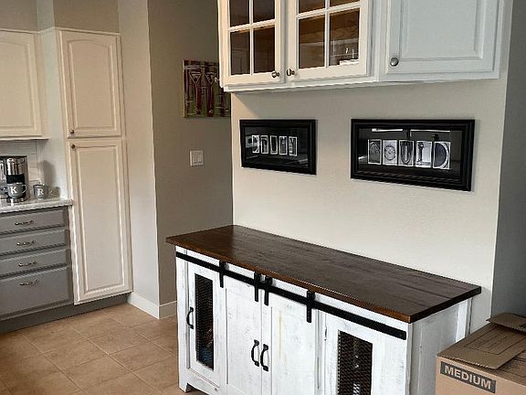 Kitchen cabinet above on wall stays. Cabinet on floor belongs to tenant.