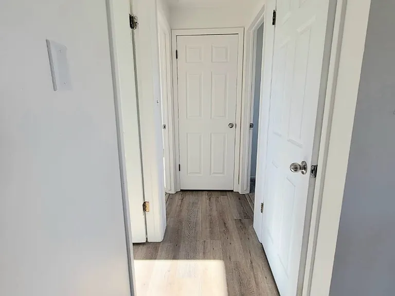 Hall Way Entrance to Bathroom Closets and Both Bedrooms