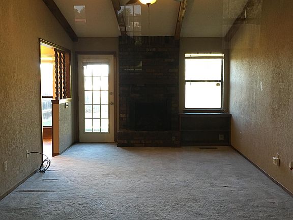 Living room with vaulted ceiling and ceiling fan.