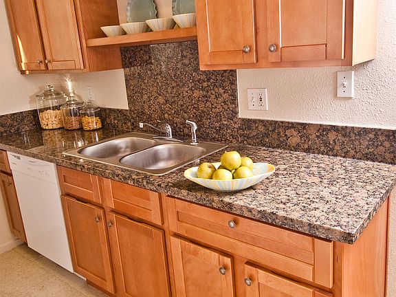 Kitchen with dishwasher, stove, refrigerator and garbage dis