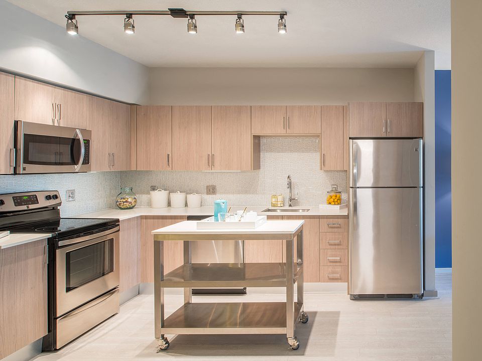 Gourmet designer kitchens with stainless steel appliances, track lighting, quartz countertops, and Italian kitchen cabinetry