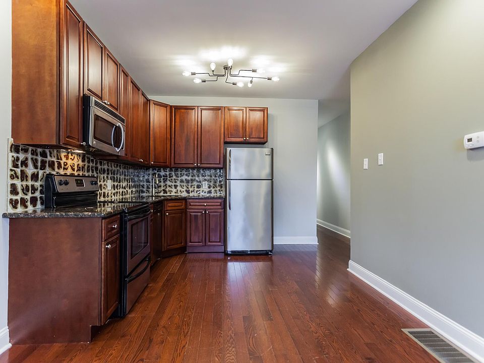Kitchen leading to upper floor hallway, bedroom, bathroom and den.