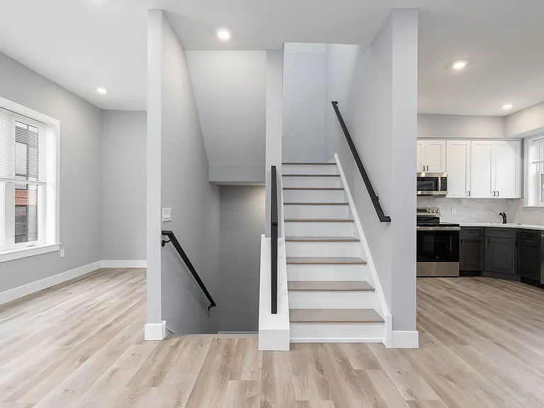 Living space and kitchen, steps to enter and stairway to roof deck