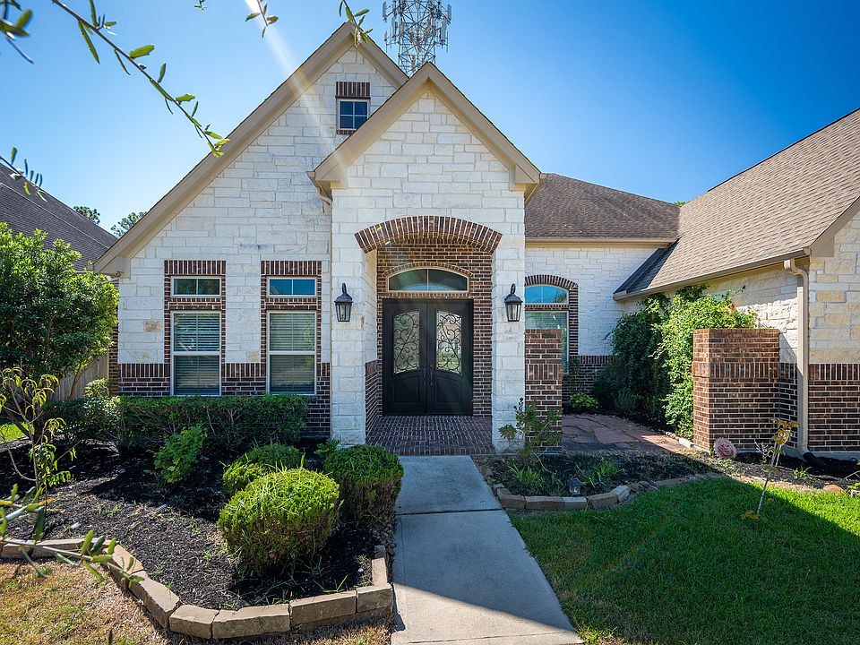 Welcome home to this stunning home in the gated community of Parc Lake Estates. The brick and stone facade is complemented by landscaped gardens and a wide driveway leading to the attached garage.