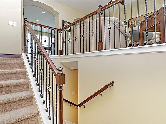 Grand two story entry with wrought iron baluster.