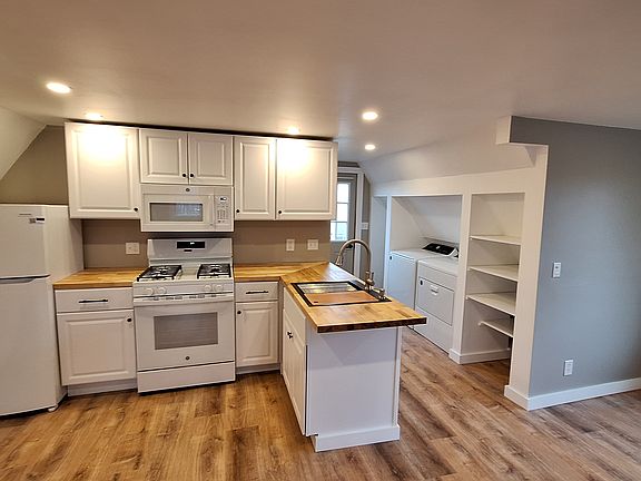 back towards entrance, shelving to right of dryer, coat closet to left of washer