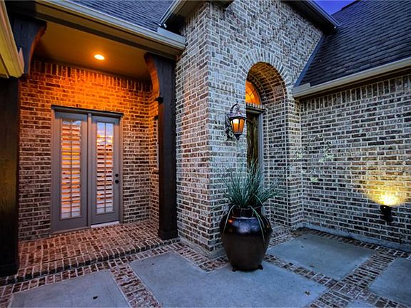 Courtyard with up lighting for showing off the home at night.