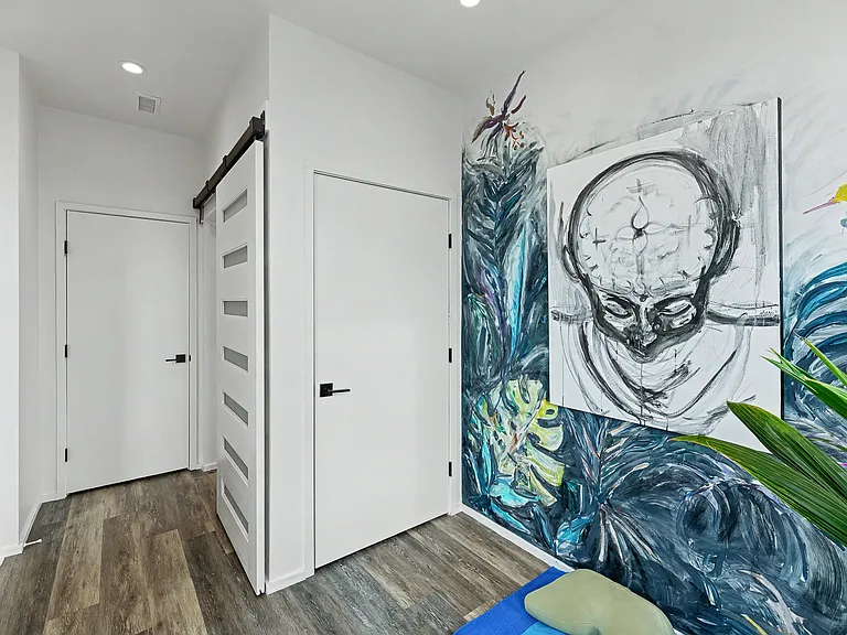 Flex space at top of stairs that can be used as a yoga/workout room and has direct rooftop patio access