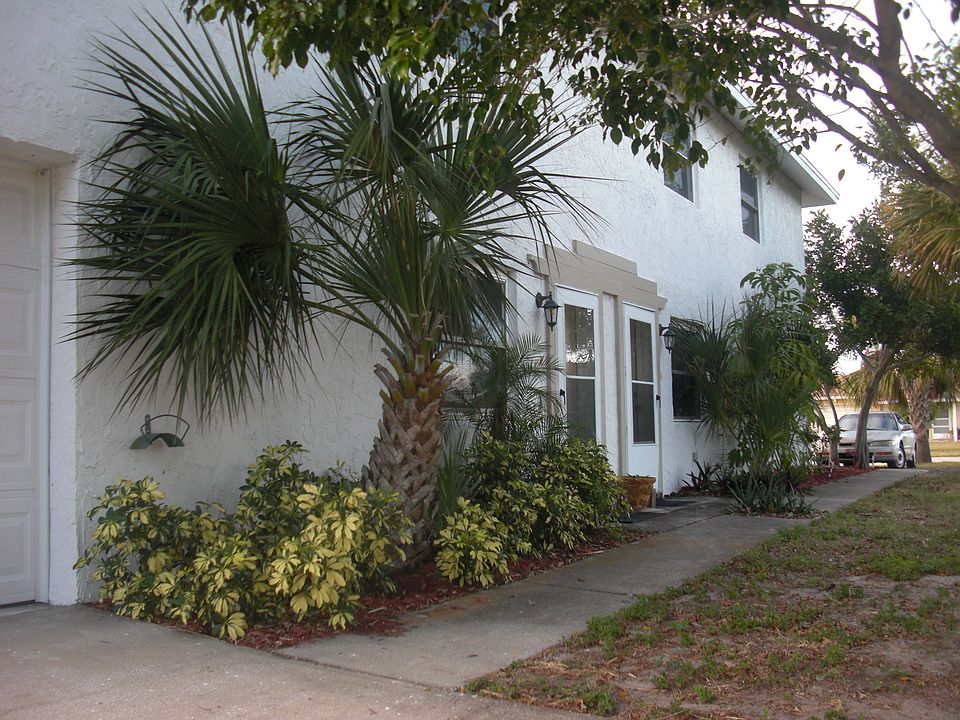 From garage drive, showing entrance at first storm door on left