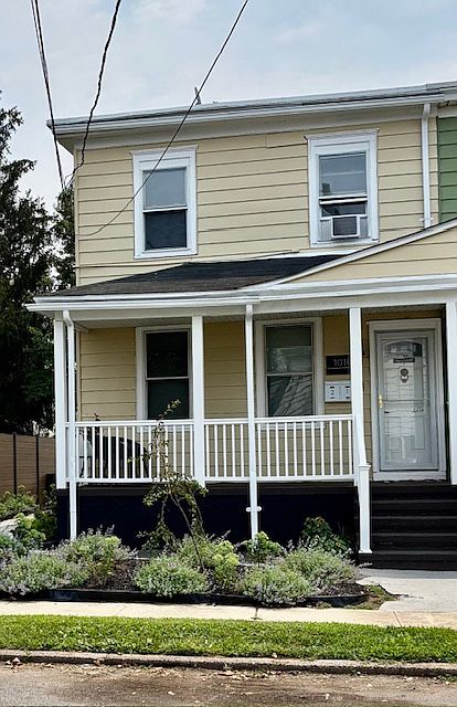 A beautifully landscaped front garden frames the newly designed house front that leads to a secure mail and package pick up area.
