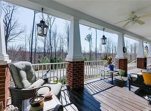 Wrap around front porch overlooks preserved woods too!