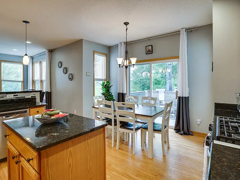 Kitchen with center island and breakfast nook leading to a large newly painted deck