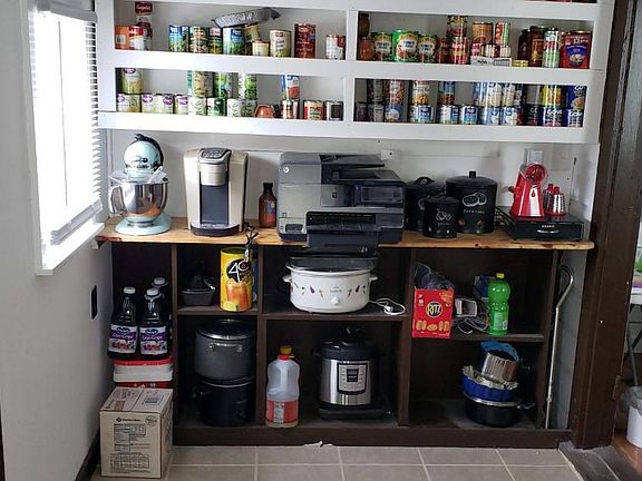 Front entrance pantry, small appliance center. You can actually cook in this area to supplement the kitchen area.