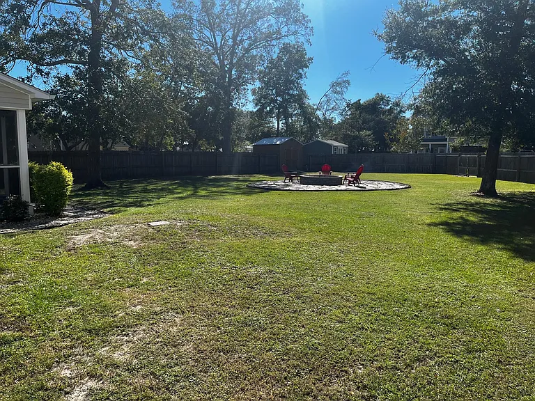 Generous fenced yard offering abundant open space for recreation, pets, or gatherings.