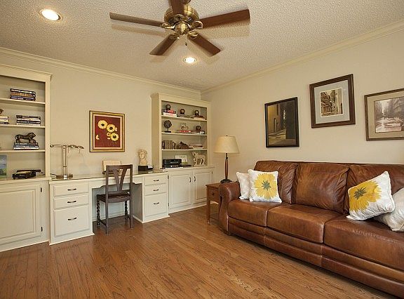 Office withwood floor and built-ins.