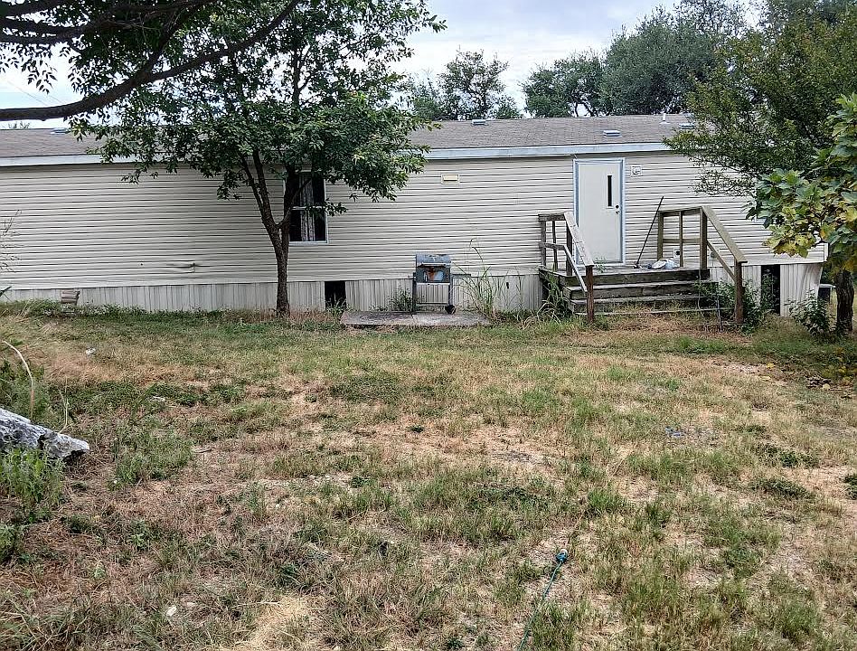 Back yard with fire pit and BBQ Pit and deck.