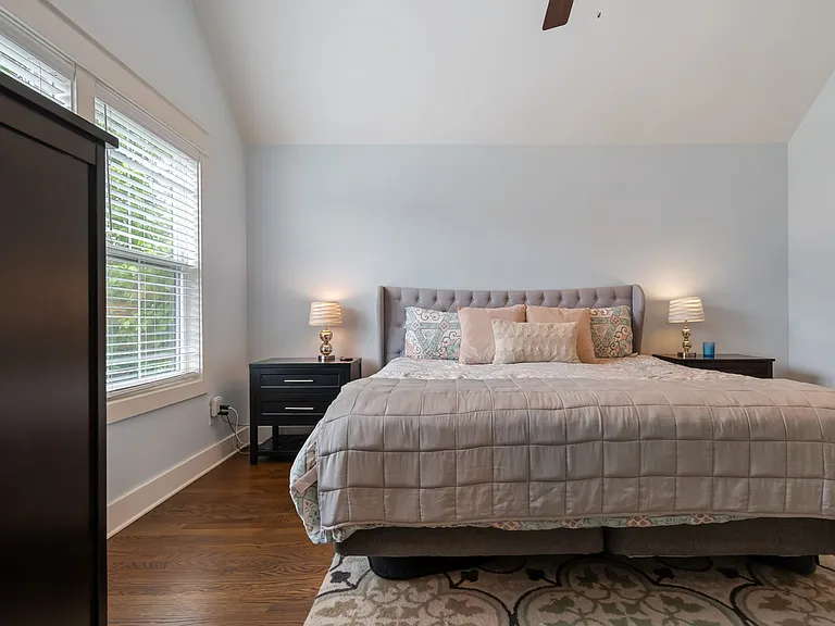 Bed, nightstands, dresser, rug, and mirror to remain; tenant to provide linens.