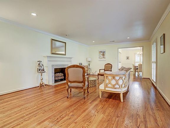 Massive size formal living room enhanced with recessed lighting, Plantation shutters on windows with views of the front porch an