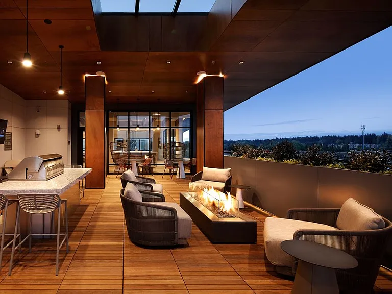Outdoor terrace lounge with fire pit, lounge seating, and grills