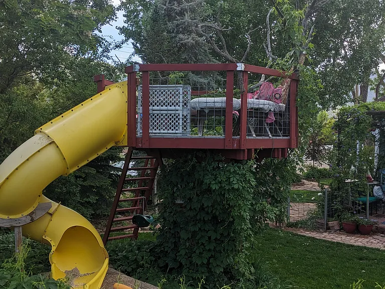 eagles nest: slide, high railing and sloped and handrail equipped stairs.