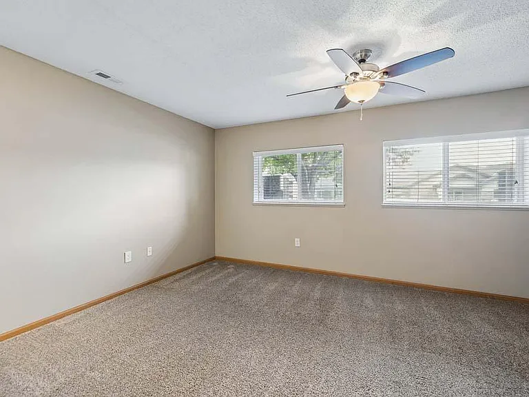 Large windows and an expansive layout fill this spacious bedroom with natural light, creating a comfortable retreat you'll look forward to every day.