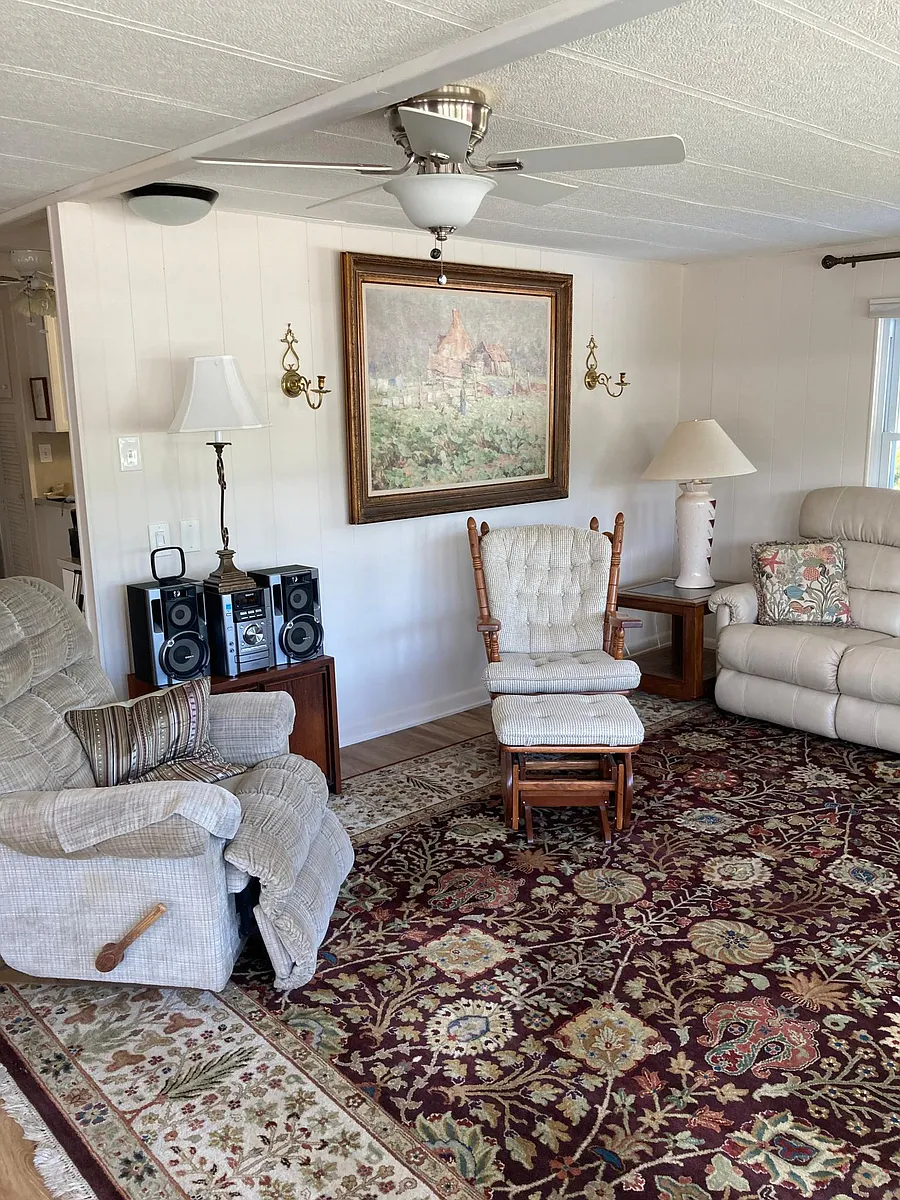 Other side of the living room. That one rocking chair with the footstool on Loan is now missing.
But you can rearrange everything, including the big TV pulling it closer - 5329 Rancho Ave