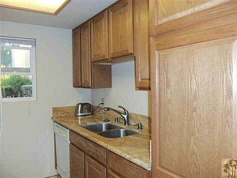 Kitchen has slab granite countertop.