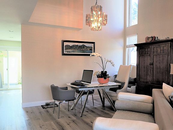 Dining room with vaulted ceiling and natural light.