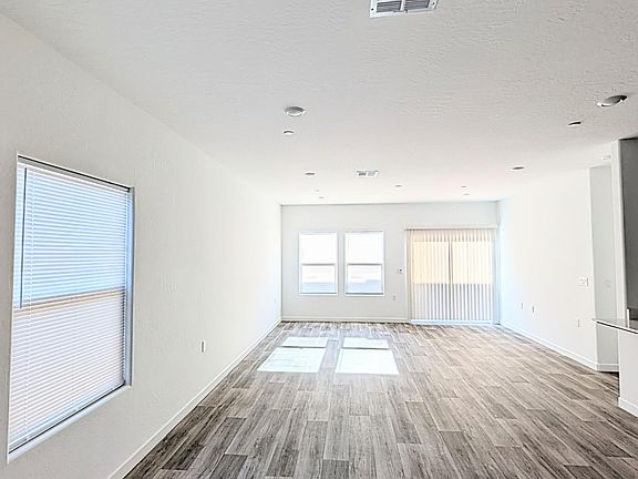 Extra large living room and dining room with hardwood floor and pre-installed blinds.