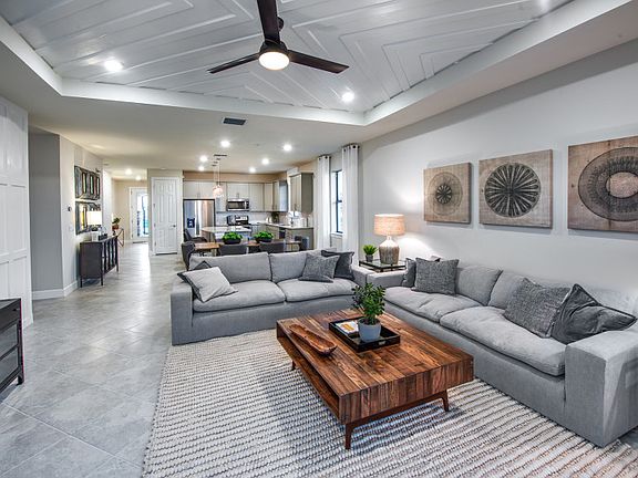 Model Representation Spacious gathering room in an open floor plan with connected tile floors