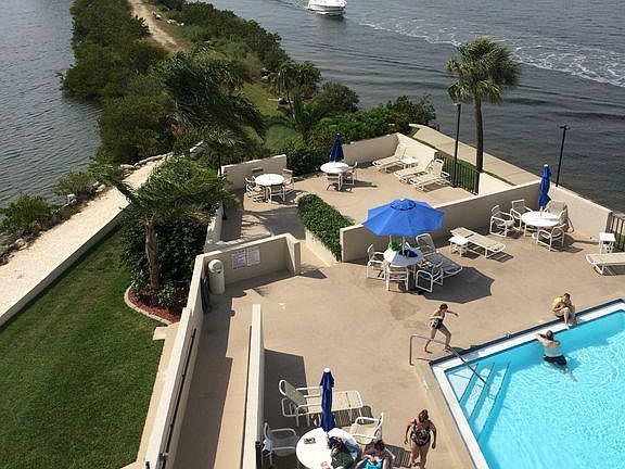 View from balcony showing pool/lounge area and nature trail 