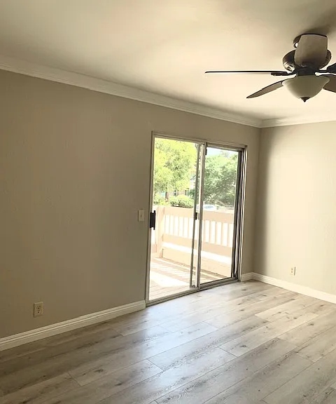 Large Master bedroom with ceiling fan, crown molding, and light grey vinyl flooring